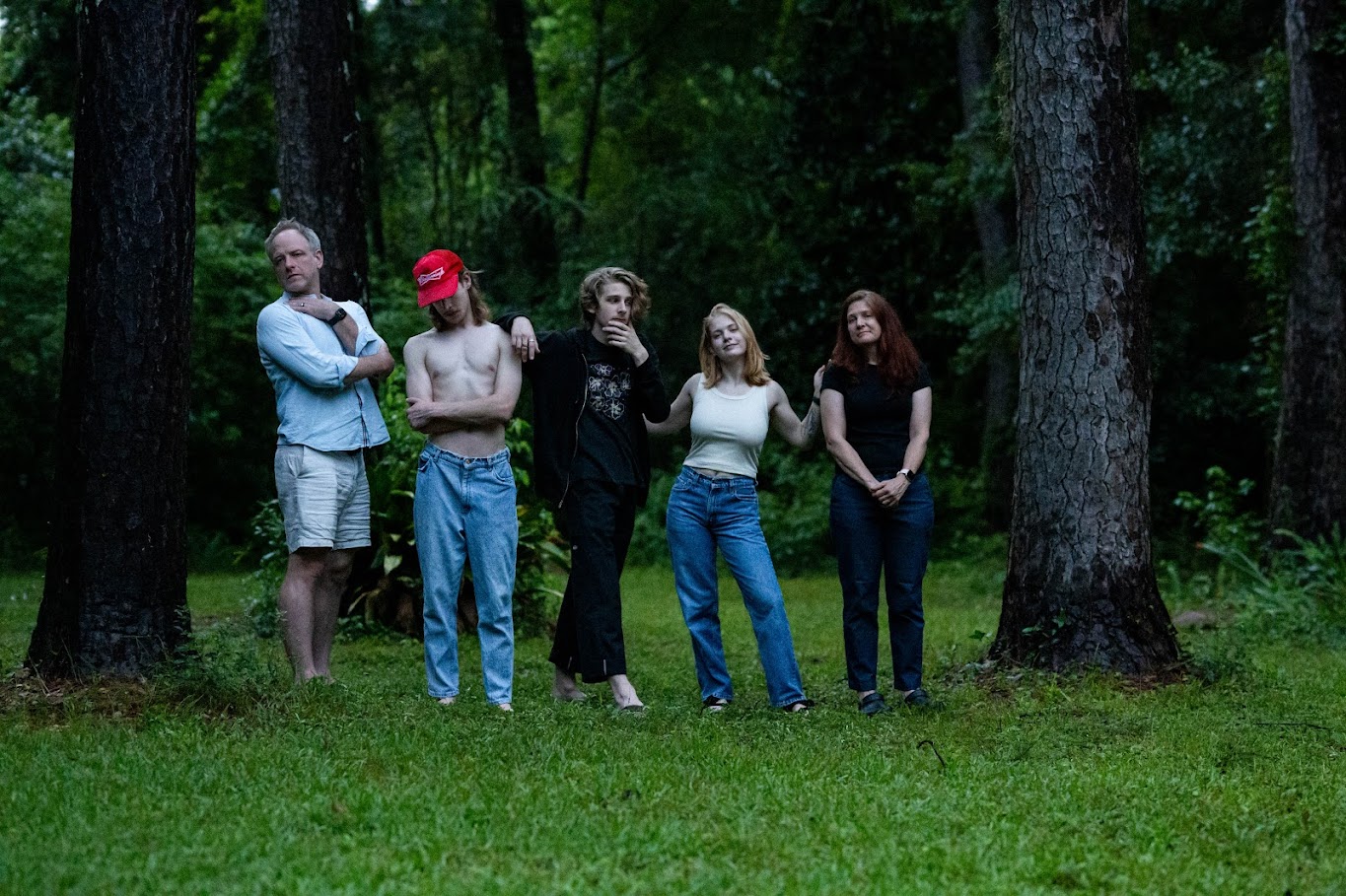 The Bennage family in a moody forest lineup