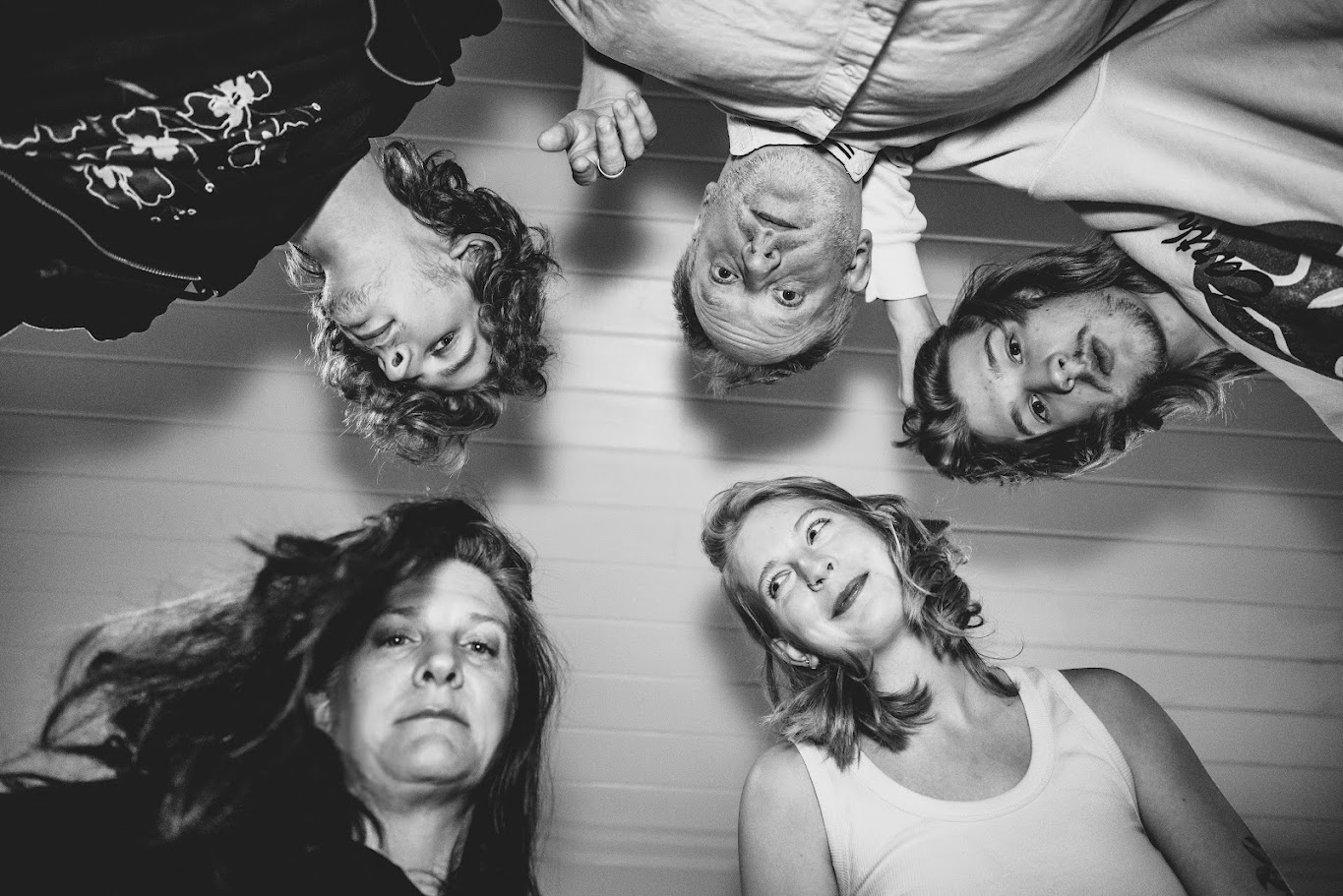 The Bennage family from above in a circle, black and white